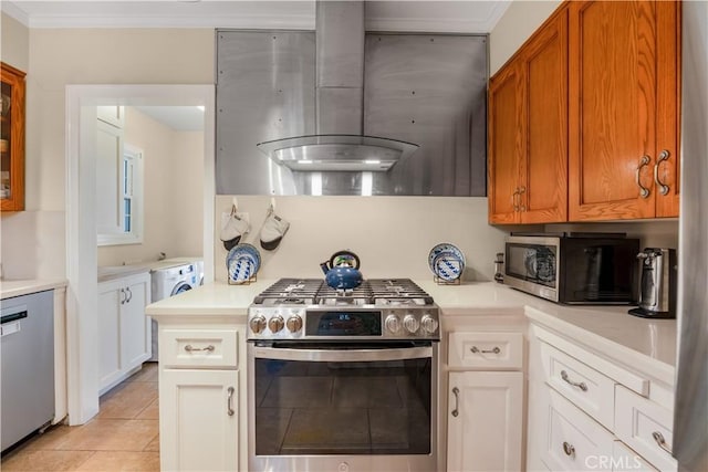 3935 Lime Ave, Long Beach, CA 90807 - kitchen featuring appliances with stainless steel finishes, exhaust hood, light countertops, washer / clothes dryer, and ornamental molding