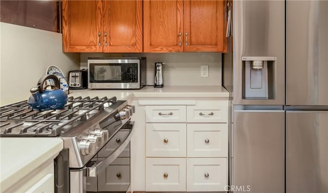 3935 Lime Ave, Long Beach, CA 90807 - kitchen with stainless steel appliances, light countertops, and brown cabinetry