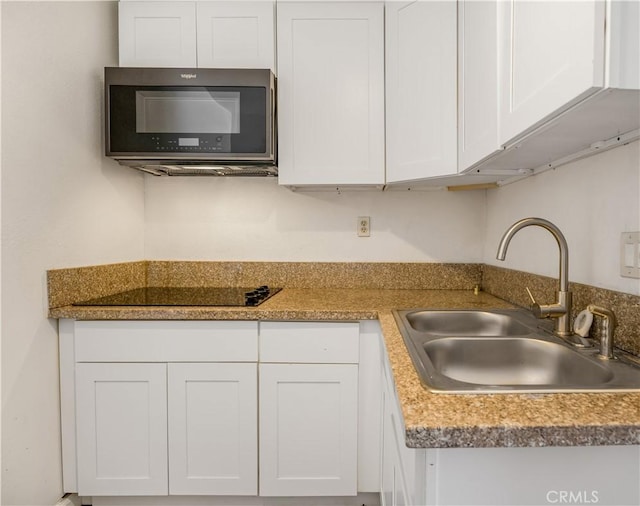 3935 Lime Ave, Long Beach, CA 90807 - kitchen featuring white cabinets and black electric cooktop
