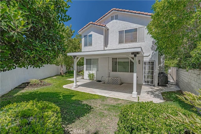 25868 Hammet Cir, Stevenson Ranch, CA 91381 - back of property featuring stucco siding, a tiled roof, a fenced backyard, and a patio