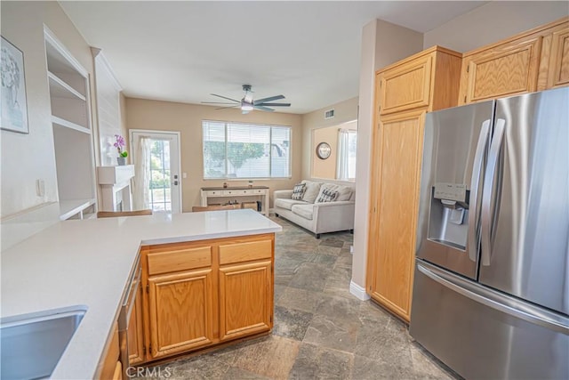 25868 Hammet Cir, Stevenson Ranch, CA 91381 - kitchen featuring stainless steel refrigerator with ice dispenser, ceiling fan, light countertops, a peninsula, and dark stone finish flooring