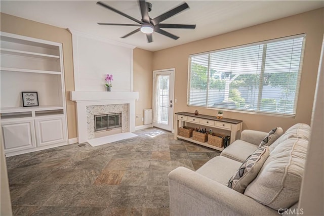 25868 Hammet Cir, Stevenson Ranch, CA 91381 - living area with ceiling fan, a fireplace, built in shelves, and stone finish flooring