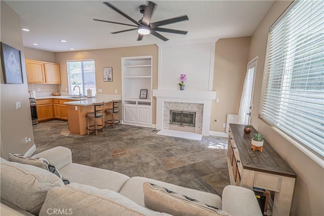 25868 Hammet Cir, Stevenson Ranch, CA 91381 - living room featuring ceiling fan, a fireplace, dark stone finish flooring, recessed lighting, and built in features