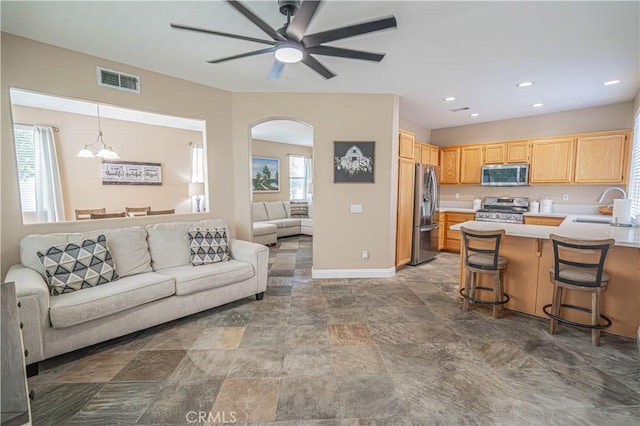 25868 Hammet Cir, Stevenson Ranch, CA 91381 - kitchen with appliances with stainless steel finishes, open floor plan, arched walkways, light brown cabinets, and light countertops