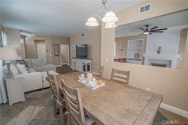 25868 Hammet Cir, Stevenson Ranch, CA 91381 - dining room featuring ceiling fan, stone finish flooring, and a fireplace