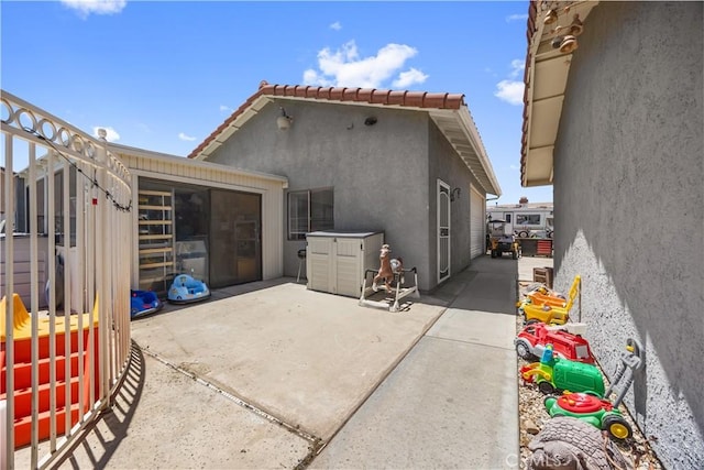 18043 Preston St, Hesperia, CA 92345 - rear view of property featuring a patio area, stucco siding, and a tile roof