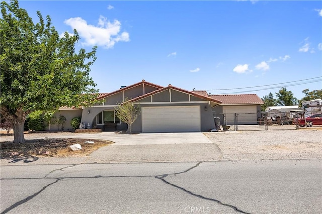 18043 Preston St, Hesperia, CA 92345 - view of front facade with an attached garage, stucco siding, concrete driveway, and a tile roof