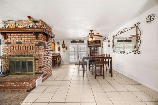 18043 Preston St, Hesperia, CA 92345 - dining room with ceiling fan, light tile patterned flooring, and a fireplace