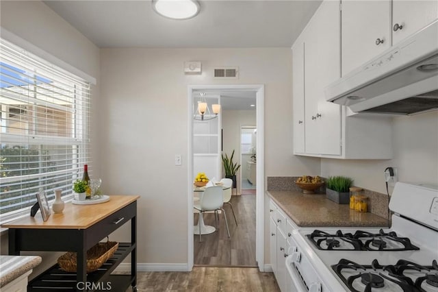 5527 Elmbank Rd, Rancho Palos Verdes, CA 90275 - kitchen with gas range gas stove, exhaust hood, white cabinets, and light wood-type flooring