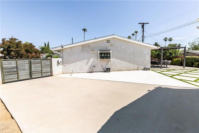 16652 Itasca St, Northridge, CA 91343 - back of property featuring stucco siding, a patio, and a gate