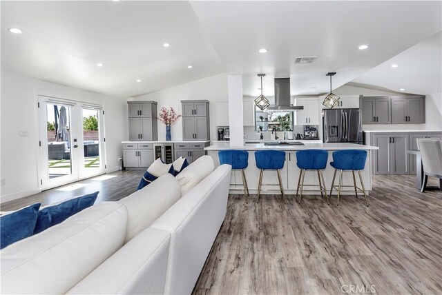 16652 Itasca St, Northridge, CA 91343 - living area with lofted ceiling, light wood-type flooring, wine cooler, and recessed lighting
