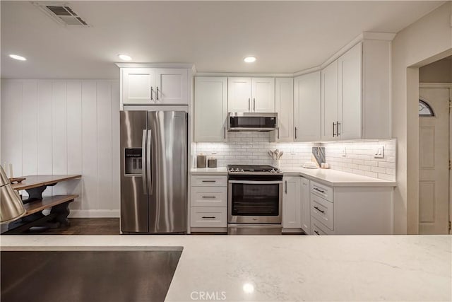 26616 Balerna Dr, Saugus, CA 91350 - kitchen with stainless steel appliances, white cabinets, decorative backsplash, recessed lighting, and dark wood-type flooring