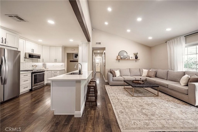 26616 Balerna Dr, Saugus, CA 91350 - living area featuring dark wood-style floors, vaulted ceiling, and recessed lighting