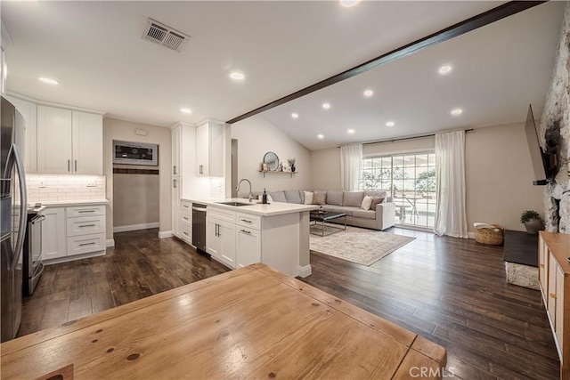 26616 Balerna Dr, Saugus, CA 91350 - kitchen featuring stainless steel appliances, a peninsula, dark wood-type flooring, open floor plan, and vaulted ceiling