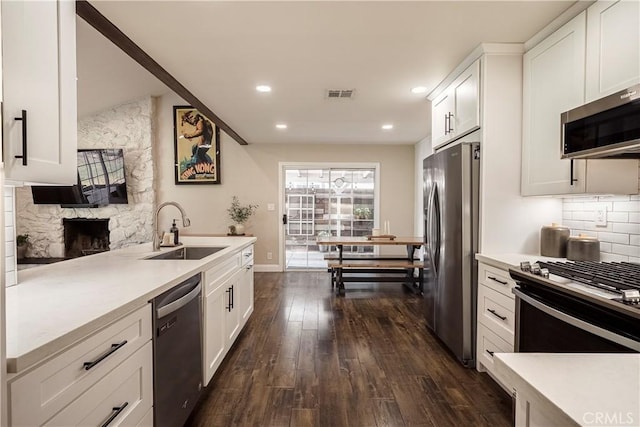 26616 Balerna Dr, Saugus, CA 91350 - kitchen featuring appliances with stainless steel finishes, dark wood-style flooring, white cabinets, light countertops, and recessed lighting