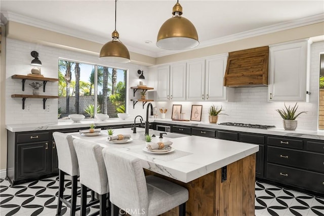 3959 Paseo Ln, Cresta, Corona, CA 92881 - kitchen with open shelves, dark cabinetry, premium range hood, white cabinets, and stainless steel gas cooktop