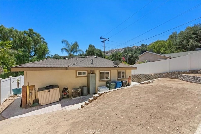 1151 El Camino Real, Simi Valley, CA 93063 - rear view of house featuring a fenced backyard, stucco siding, and a patio