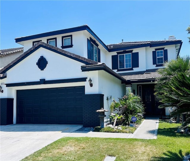 16461 Medinah St, Fontana, CA 92336 - view of front of property featuring brick siding, driveway, stucco siding, a front lawn, and a tile roof