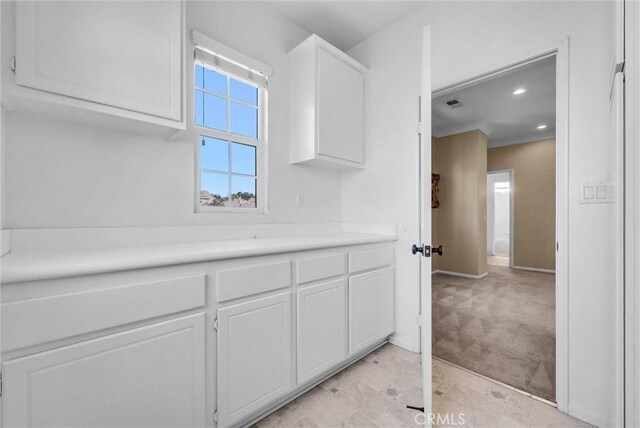 16461 Medinah St, Fontana, CA 92336 - kitchen featuring white cabinets, light countertops, light carpet, and recessed lighting