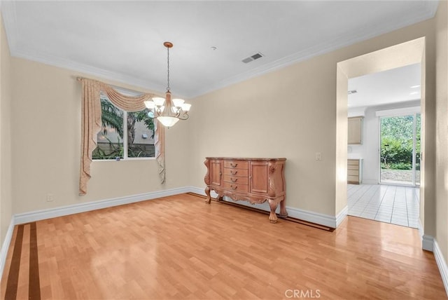 16461 Medinah St, Fontana, CA 92336 - spare room with light wood-style floors, crown molding, and a chandelier