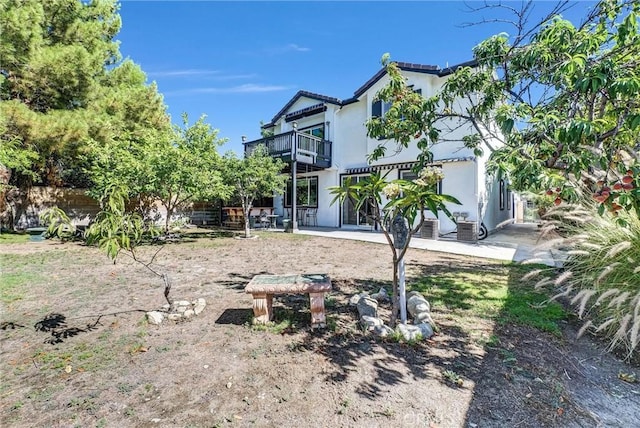 16461 Medinah St, Fontana, CA 92336 - rear view of house with a balcony, stucco siding, and a patio
