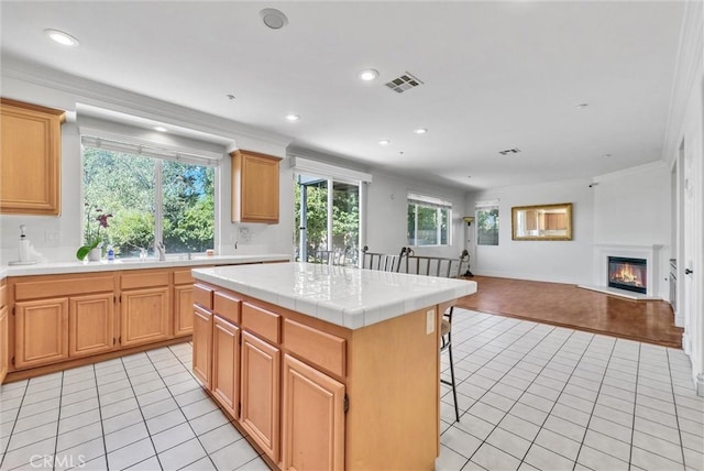 16461 Medinah St, Fontana, CA 92336 - kitchen featuring light tile patterned floors, open floor plan, recessed lighting, tile countertops, and a center island