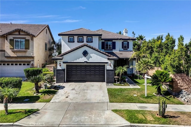 16461 Medinah St, Fontana, CA 92336 - view of front of property with driveway, stucco siding, a front lawn, a tiled roof, and a garage