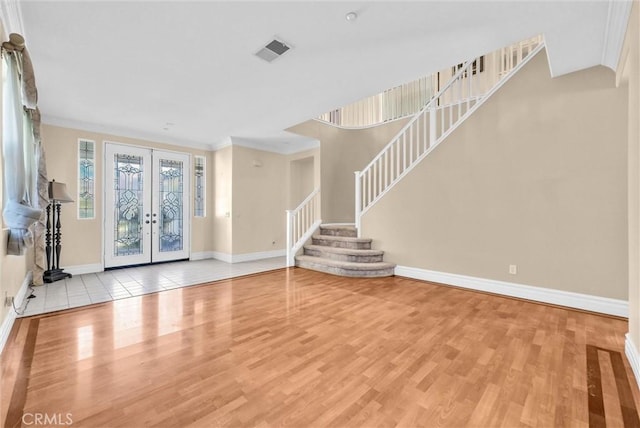 16461 Medinah St, Fontana, CA 92336 - unfurnished living room with french doors, wood finished floors, stairway, and crown molding