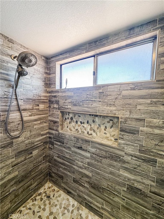 741 Ocotillo Rd, Blythe, CA 92225 - bathroom featuring tiled shower and a textured ceiling