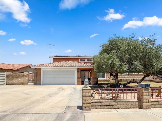 741 Ocotillo Rd, Blythe, CA 92225 - view of front of home featuring a tile roof, roof mounted solar panels, driveway, a garage, and stucco siding