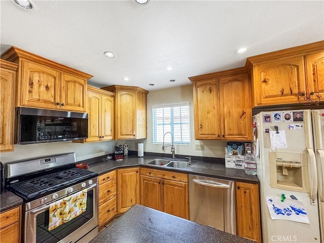741 Ocotillo Rd, Blythe, CA 92225 - kitchen with appliances with stainless steel finishes, dark countertops, brown cabinets, and recessed lighting