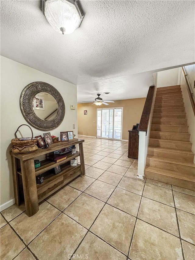 741 Ocotillo Rd, Blythe, CA 92225 - hallway featuring light tile patterned flooring, a textured ceiling, and stairs