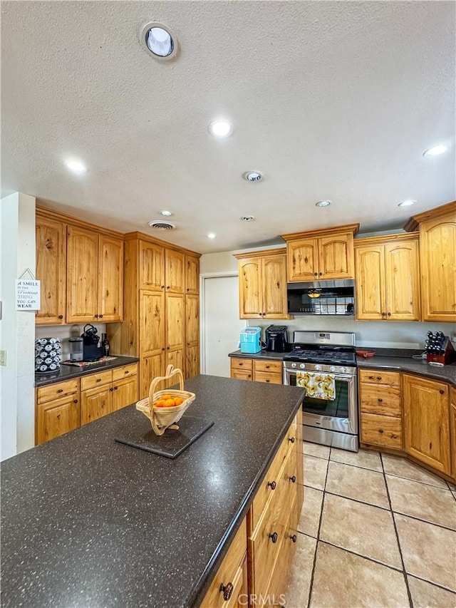 741 Ocotillo Rd, Blythe, CA 92225 - kitchen with appliances with stainless steel finishes, light tile patterned floors, a textured ceiling, recessed lighting, and dark stone counters
