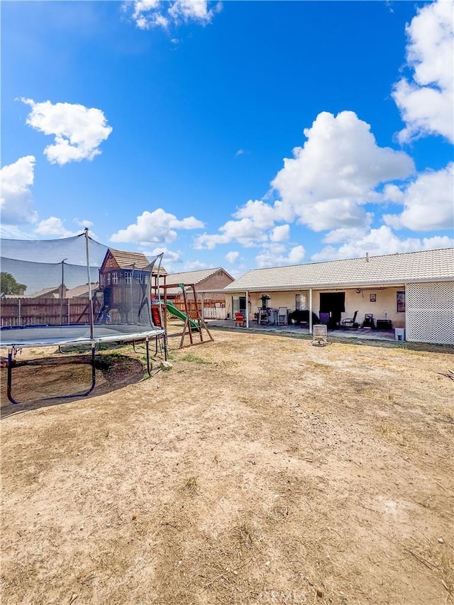 204 Shaded Palm, Blythe, CA 92225 - view of yard featuring a trampoline, a playground, and a patio