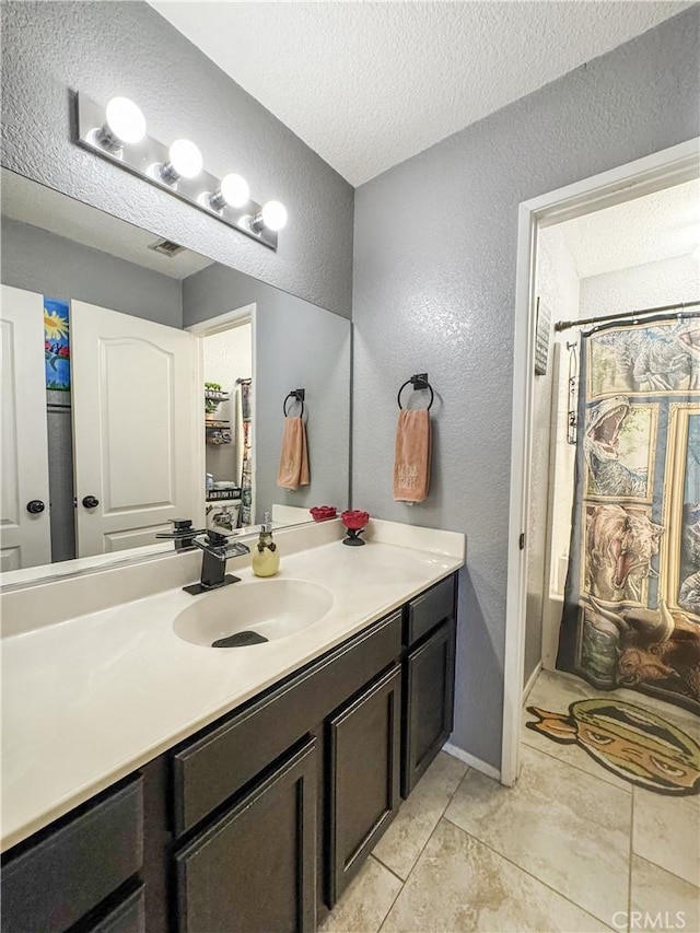 204 Shaded Palm, Blythe, CA 92225 - bathroom with a textured wall, vanity, a textured ceiling, and tile patterned flooring