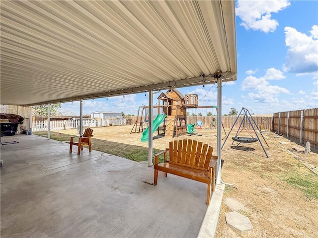 204 Shaded Palm, Blythe, CA 92225 - fenced backyard featuring a playground and a patio area