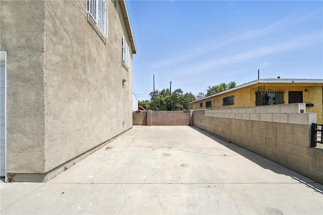 711 E 118th St, Los Angeles, CA 90059 - view of property exterior with stucco siding, a fenced backyard, and a patio area