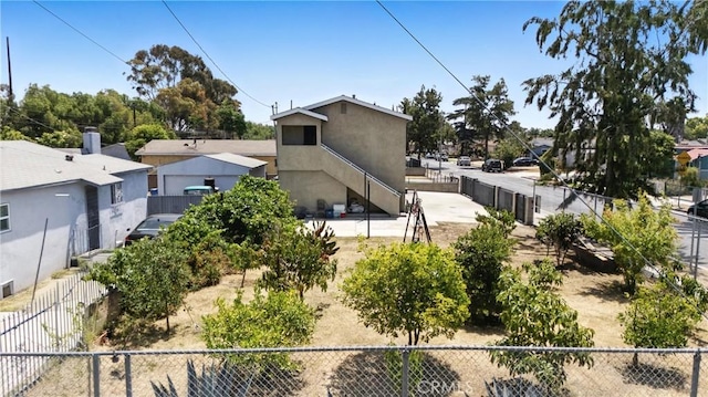 711 E 118th St, Los Angeles, CA 90059 - view of property exterior featuring stucco siding and stairs