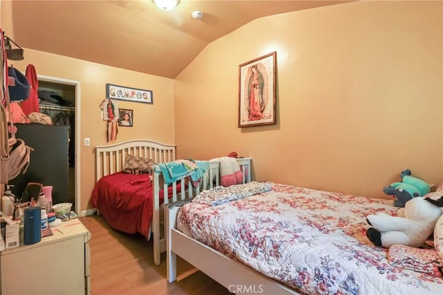 2734 S Redondo Blvd, Los Angeles, CA 90016 - bedroom featuring wood finished floors, lofted ceiling, and a walk in closet