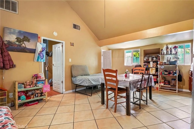 2734 S Redondo Blvd, Los Angeles, CA 90016 - dining room featuring healthy amount of natural light, light tile patterned floors, and lofted ceiling
