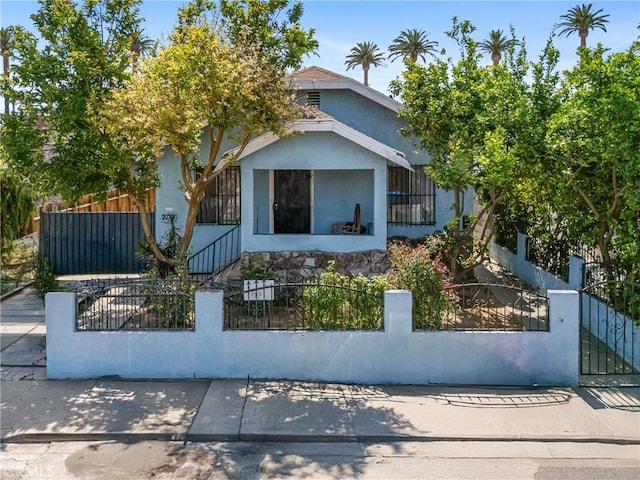 2734 S Redondo Blvd, Los Angeles, CA 90016 - view of front of home with stucco siding and a fenced front yard