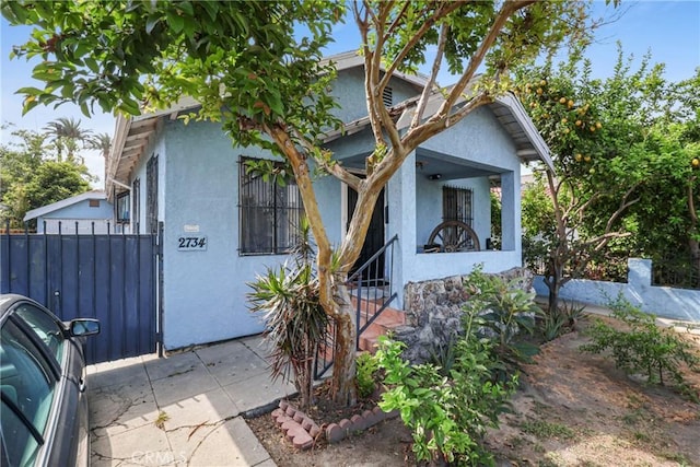 2734 S Redondo Blvd, Los Angeles, CA 90016 - view of front of home with stucco siding and a gate