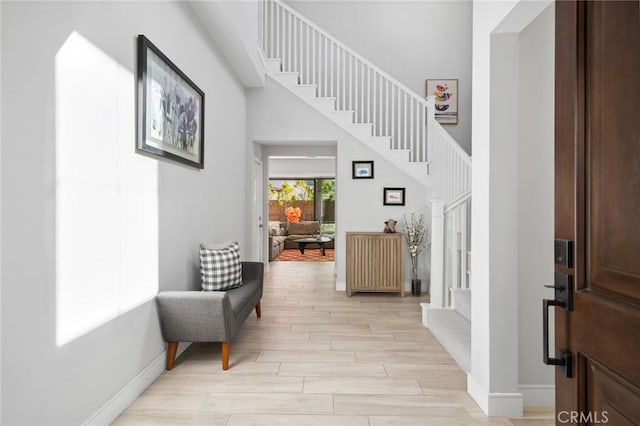 152 Plum Lily, Irvine, CA 92618 - entryway featuring light wood finished floors, stairs, and a high ceiling