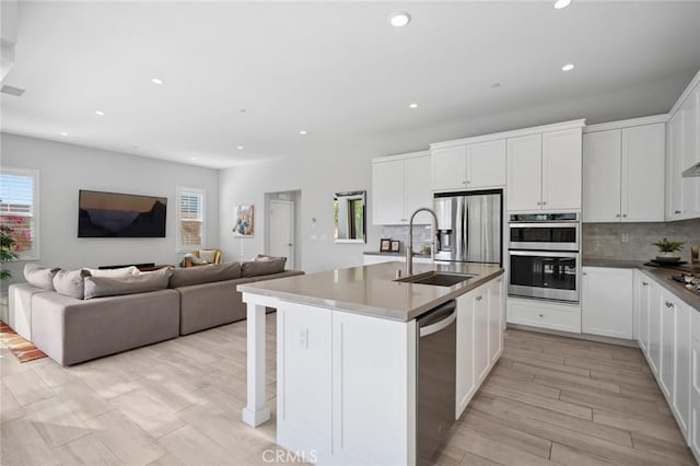152 Plum Lily, Irvine, CA 92618 - kitchen with appliances with stainless steel finishes, plenty of natural light, recessed lighting, tasteful backsplash, and open floor plan
