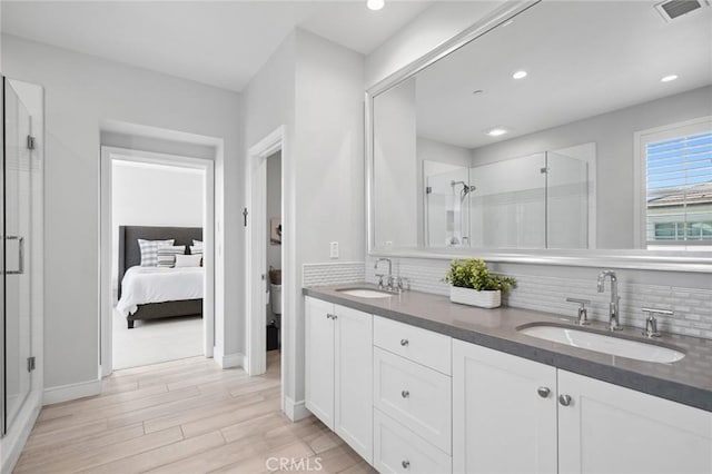 152 Plum Lily, Irvine, CA 92618 - ensuite bathroom with a stall shower, backsplash, wood finished floors, double vanity, and recessed lighting