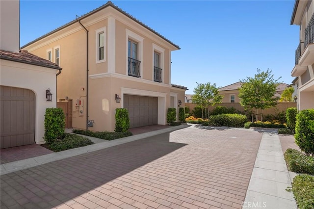 152 Plum Lily, Irvine, CA 92618 - view of front of house with stucco siding, a tile roof, and a garage