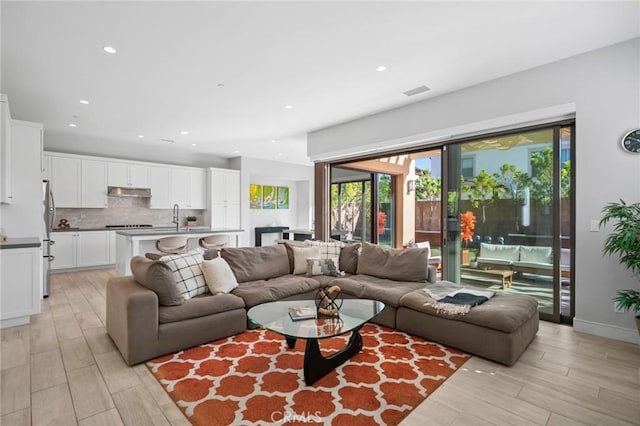 152 Plum Lily, Irvine, CA 92618 - living room with recessed lighting and light wood-style flooring