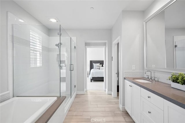 152 Plum Lily, Irvine, CA 92618 - ensuite bathroom with vanity, a shower stall, a bath, wood finished floors, and backsplash