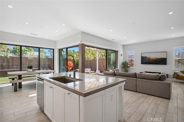 152 Plum Lily, Irvine, CA 92618 - kitchen featuring white cabinets, recessed lighting, light wood-type flooring, dishwasher, and a kitchen island with sink