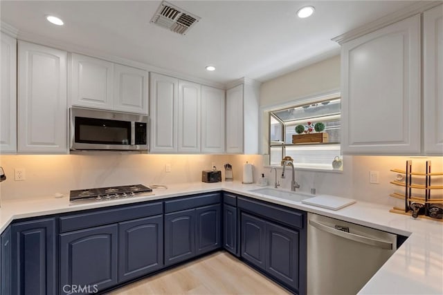 2613 Carnegie Ln # B, Redondo Beach, CA 90278 - kitchen with stainless steel appliances, blue cabinetry, white cabinetry, and recessed lighting